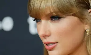 Taylor Swift's profile, with striking blue eyes and blonde bangs, hints at her latest Spotify release.