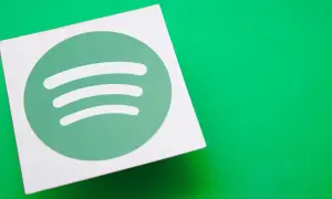 A white square with the green Spotify logo sits on a bright green surface, hinting at the platform's popularity and its impressive spotify stream count.