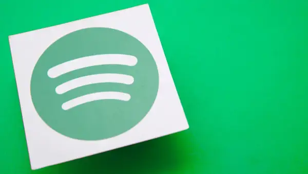 A white square with the green Spotify logo sits on a bright green surface, hinting at the platform's popularity and its impressive spotify stream count.